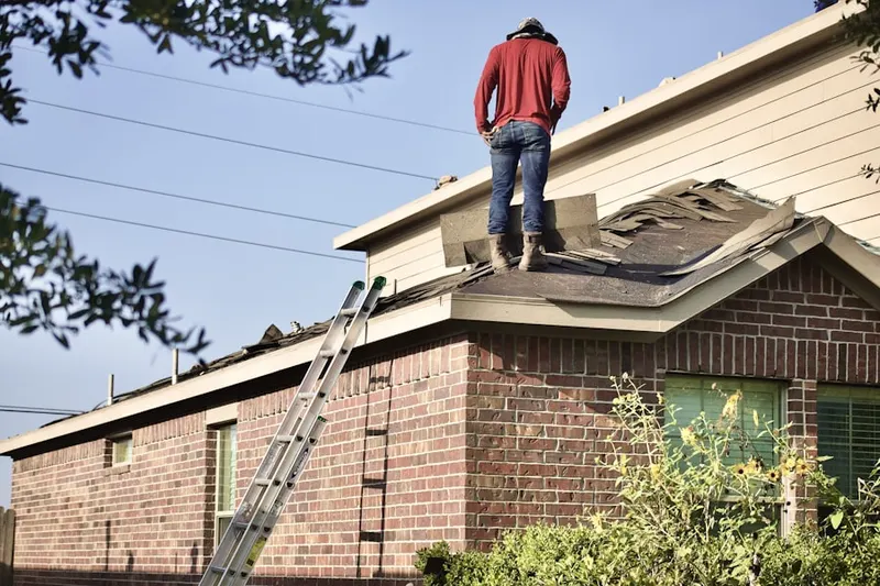 Professional roofer working on a residential roof in Prunedale